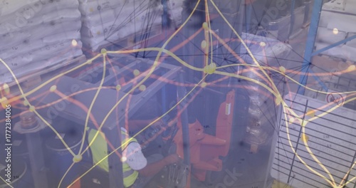 Forklift operator wearing safety gear lifting pallets of sacks in warehouse, with network overlay