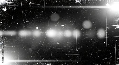 A black and white image featuring scratches, dust, and a bright horizontal light streak across the center