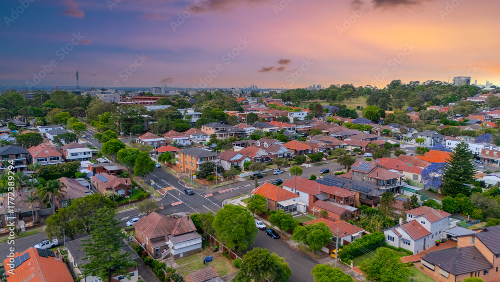 Fototapeta premium Panorama Sunset aerial drone view of western Sydney Suburbs of Canterbury Burwood Ashfield Marrickville Campsie with Houses roads and parks in Sydney New South Wales NSW Australia