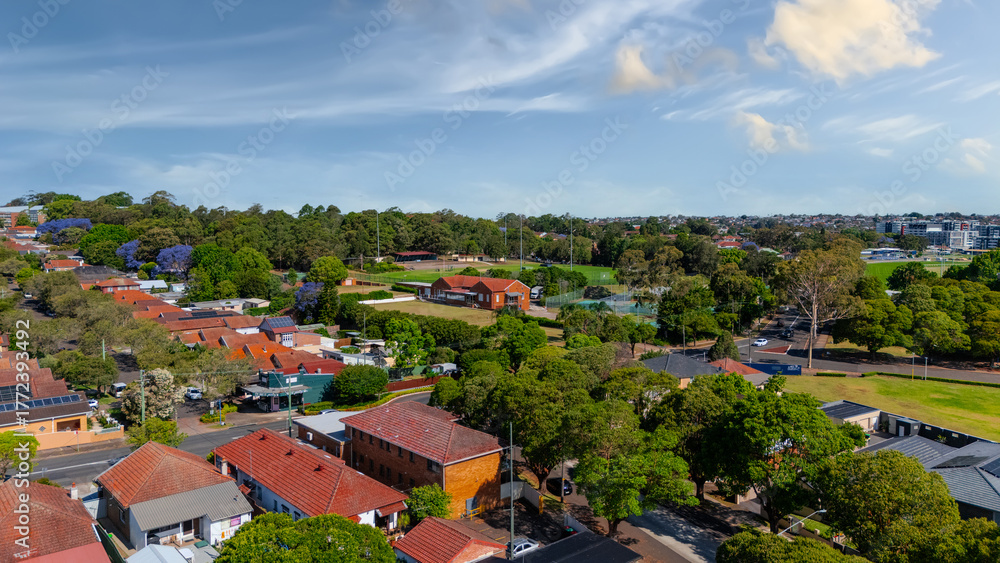 Obraz premium Panorama Sunset aerial drone view of western Sydney Suburbs of Canterbury Burwood Ashfield Marrickville Campsie with Houses roads and parks in Sydney New South Wales NSW Australia
