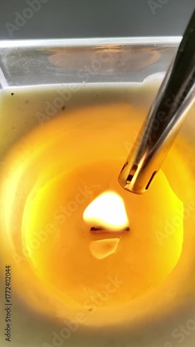 Lighting a decorative scented candle with a lighter