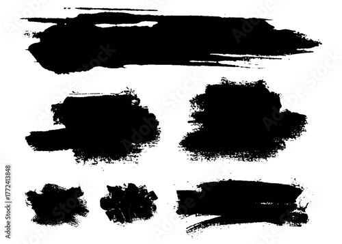 Collection of black ink brush strokes and smudges representing artistic expression and creative design elements on a white background