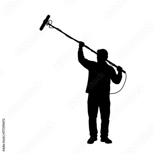 Focused Silhouette of Sound Engineer Holding a Boom Microphone for Audio Capture