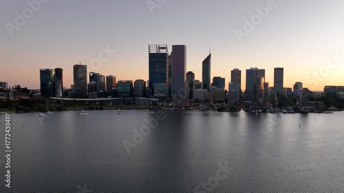 Wallpaper Mural Aerial view of Perth's modern skyline with its towering buildings reflected in the calm Swan River under a soft sunset glow, Perth, Western Australia, Australia. Torontodigital.ca