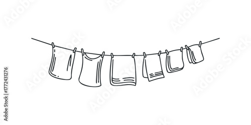 Laundry drying on a clothesline with clothespins