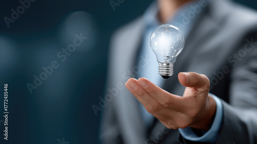 Businessman holding glowing light bulb innovation concept, creative idea, futuristic technology, inspiration, success, modern business