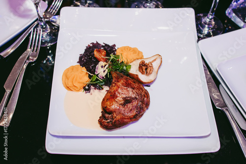 High service restaurant. Duck leg with vegetables and pear with gorgonzola.