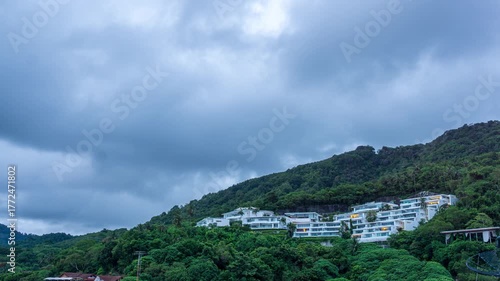 Sunset timelapse of modern villas on a hillside with epic dramatic clouds and glowing evening sky