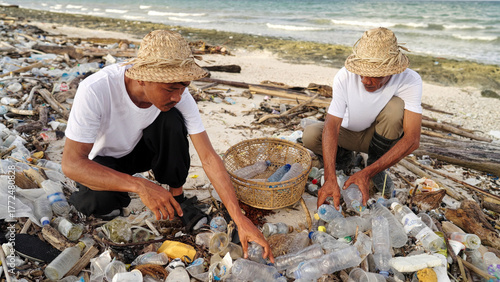Indonesian men collecting plastic bottles on a polluted bean in indonesia, waste pickers, informal waste management, picking up waste for recycling, asia, ocean pollution