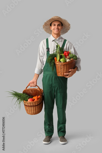 Male farmer with baskets of...