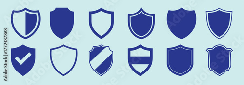 Collection of blue shield icons with various designs on a light blue background