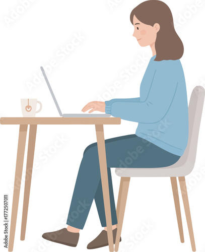 A woman sits at a table, working on a laptop, with a cup of tea.