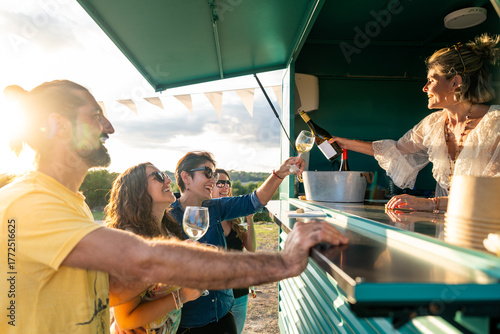 Friends enjoying wine at outdoor food truck party