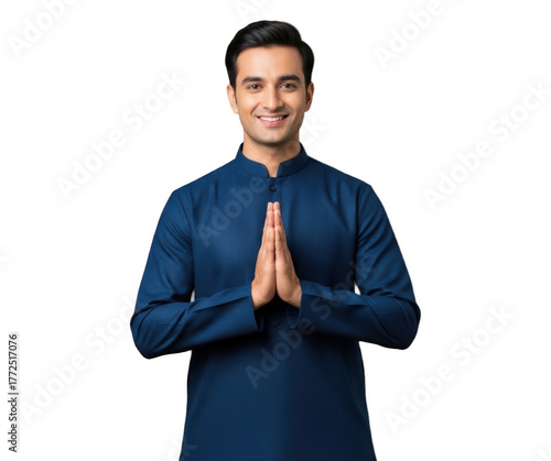 A smiling man in a blue kurta with his hands clasped in prayer, against transparent background