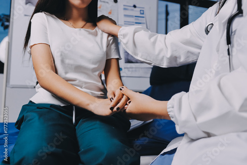 Doctor giving hope. Close up shot of young female physician leaning forward to smiling elderly lady patient holding her hand in palms. Woman caretaker in white coat supporting encouraging old person