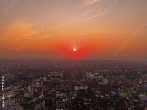 Wallpaper Mural Aerial view of a cityscape bathed in the warm glow of the setting sun, casting long shadows across the buildings, Yogyakarta, Daerah Istimewa Yogyakarta, Indonesia. Torontodigital.ca