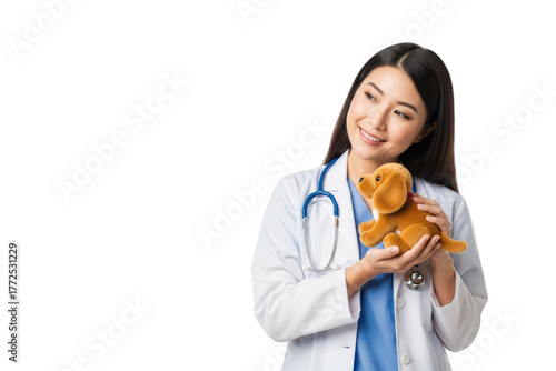 A smiling female doctor holding a plush toy dog, against transparent background