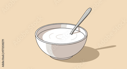 Simple white bowl filled with creamy yogurt and a spoon resting inside, perfect for breakfast or healthy eating concepts