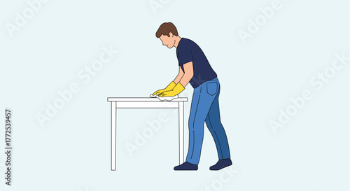 Dedicated man in yellow gloves meticulously cleaning a white table surface with a cloth, ensuring a spotless finish for a pristine environment