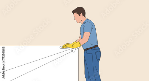 Man wearing yellow gloves meticulously wipes down a white surface, embodying dedication to cleanliness and hygiene in any setting