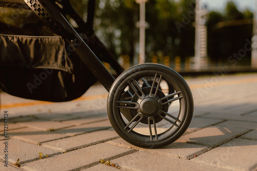 Detail of stroller wheels at the train station at sunset