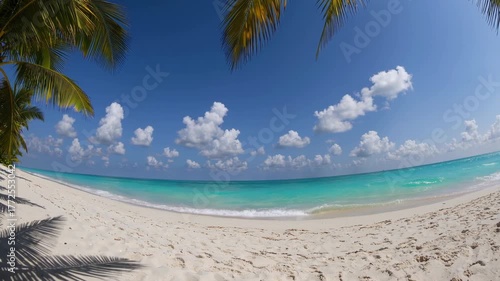 Relaxing beach day with clear blue waters and bright skies in the afternoon sun