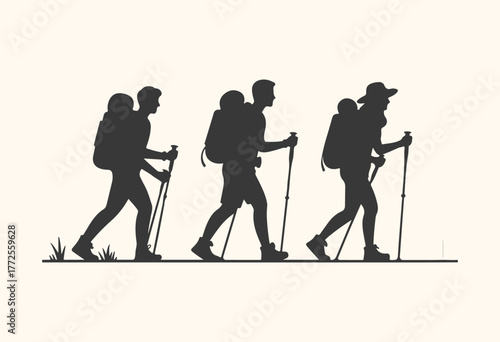 Silhouette of three hikers with backpacks and trekking poles walking in a line