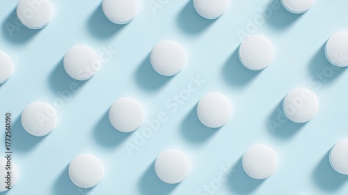 Wallpaper Mural shallow. White tablets arranged in a geometric pattern on a light blue surface. STEM education sheets, lab safety posters, designed for biotech research communications, used by art directors. Torontodigital.ca