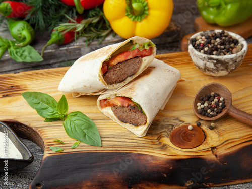 Lula kebab in lavash on a wooden board