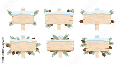 Winter wooden signs with pine cones and snow on rustic background