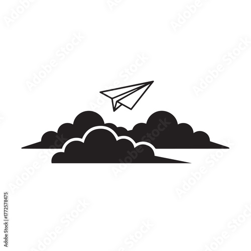 Silhouette of a paper airplane flying above clouds