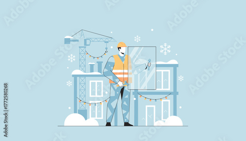 Construction worker installing window glass on a snowy building site during winter holidays