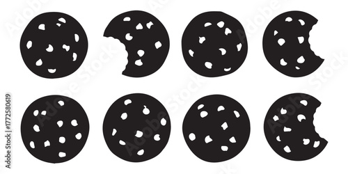Eight black circular cookies with white chocolate chips, with four of them showing a bite taken out, arranged in two rows on a