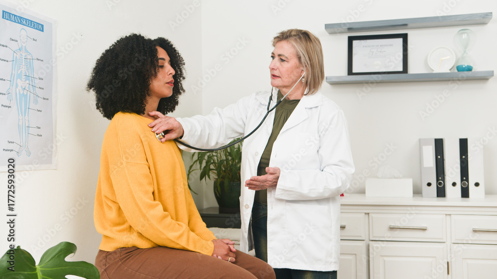 Fototapeta premium Compassionate Doctor Examining Patient in Clinic With Stethoscope and White Coat During Checkup