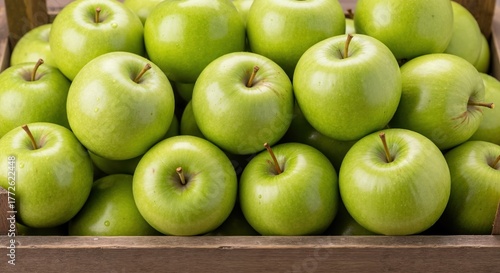 Close-up of fresh green Granny Smith apples in a wooden crate. Healthy organic fruit from the autumn harvest