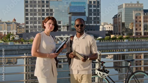 Wallpaper Mural Zoom in portrait of two serious multiethnic colleagues posing for camera in urban space on summer day Torontodigital.ca
