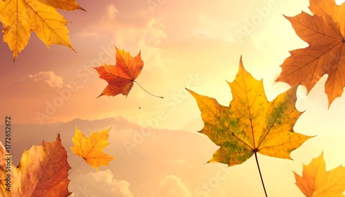 Golden and orange maple leaves gently falling against a soft, sunlit sky with fluffy white clouds and blurred mountain silhouettes