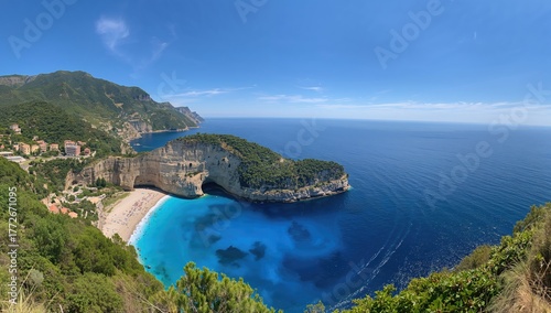 Wide-angle scene of a gulf with towering cliffs overlooking another bay in a protected coastal park, showcasing the vibrant blue sea under a clear summer sky