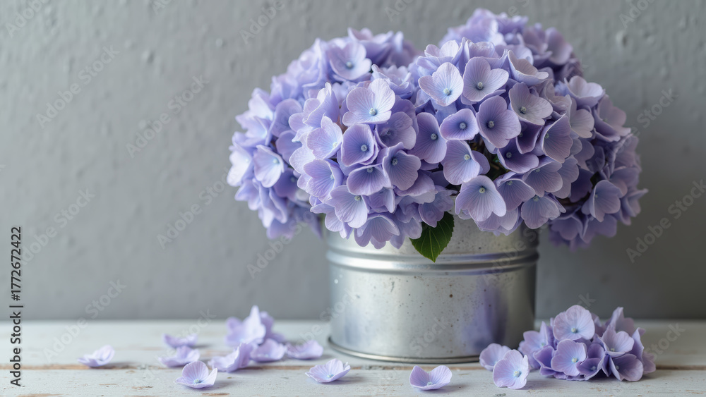 Obraz premium Beautiful purple flowers in silver metal pot, creating serene and calming atmosphere. delicate petals and soft colors enhance aesthetic appeal
