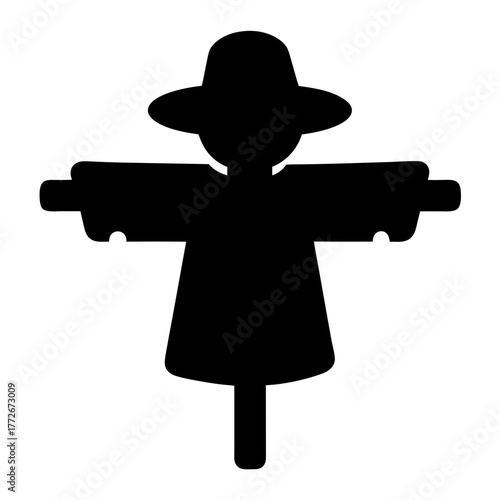 Solid black silhouette of a scarecrow with a hat and outstretched arms