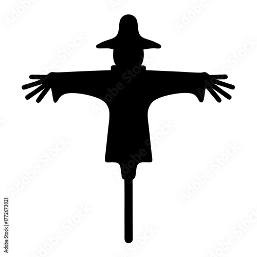 Black silhouette of a classic scarecrow figure in a field of crops