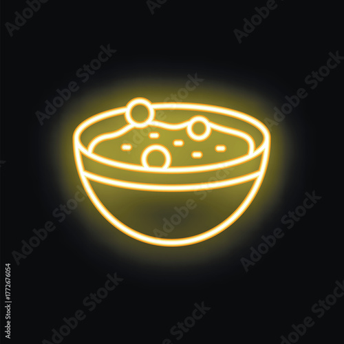 Yellow neon sign showing a bowl of soup with croutons on a black background