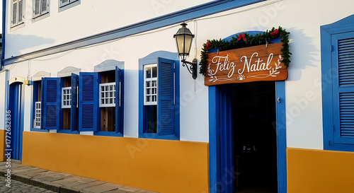 Traditional architecture with blue shutters and a Feliz Natal sign decorated for the holiday season