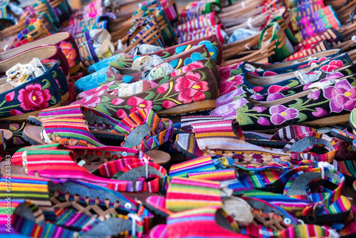 View of an exhibition of handcrafted Mexican shoes in full color, sandals