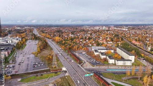 E4 motorway from Stockholm towards Uppsala, near Kista, aerial view, with autumn colors and the sprawling suburbs of the city, Sweden