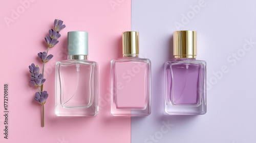 Flatlay of pastel perfume bottles with gold and silver caps, pink and lavender liquid, and lavender flower on pink and purple background, evoking calm and elegant mood
