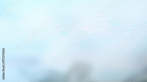 Soft analog VHS signal with smooth blue and white distortion waves. Abstract pastel glitch texture with light flickering and analog interference.