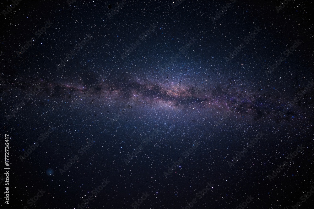 Fototapeta premium Starry night sky featuring the Milky Way galaxy with stars and cosmic dust in the backdrop