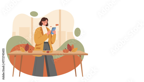 Young woman smiling while using a smartphone next to autumn table decorations