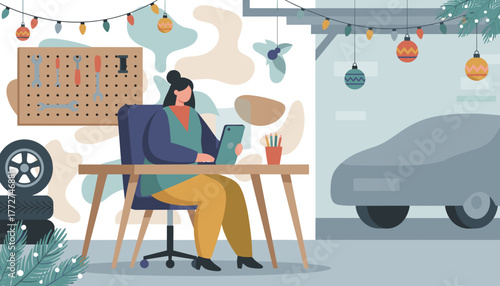 Freelancer works on a tablet in a festive garage workshop next to tools and a covered car